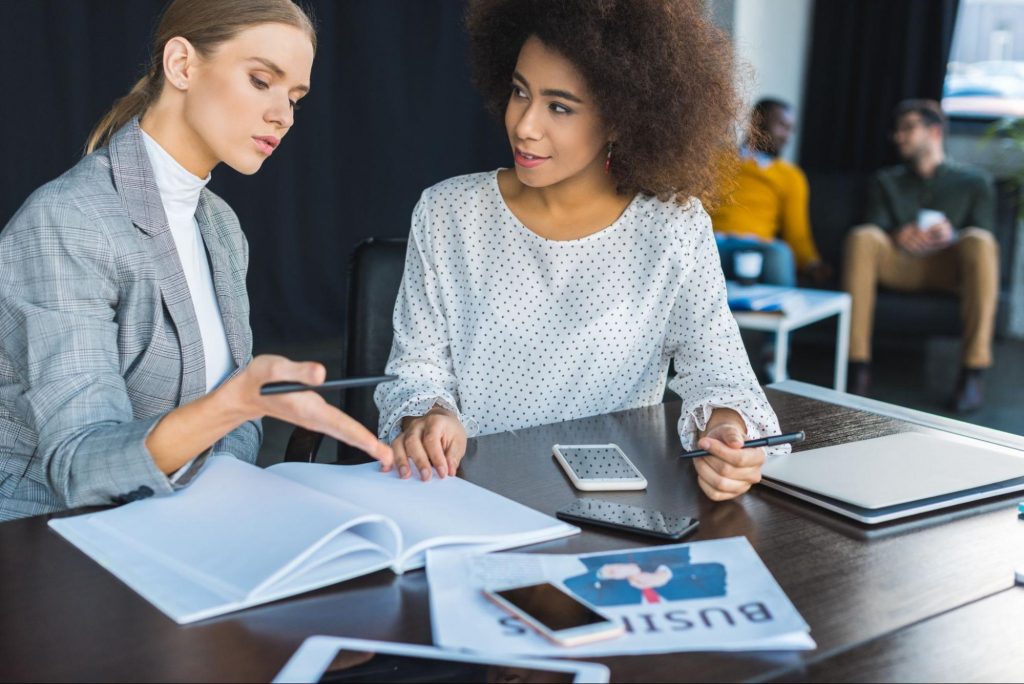 Image showing two women in a business consultation | In Celebration of International Women’s Day: Resources for Women-Owned Businesses blog by Ready Ads