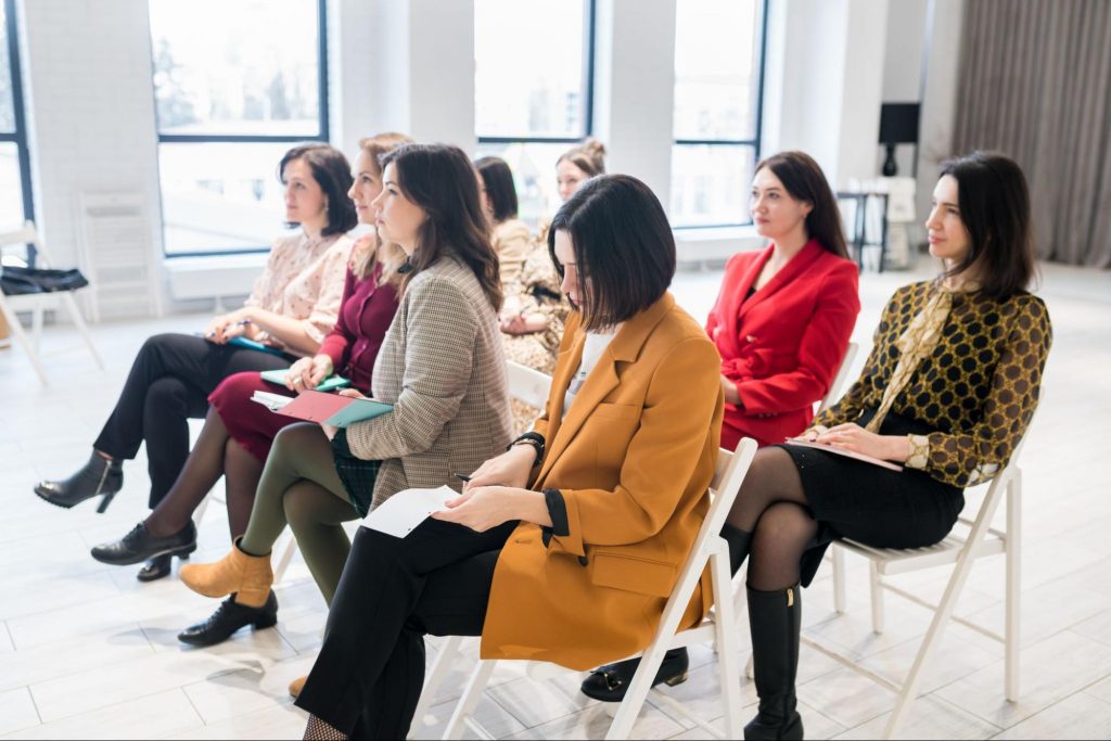 Image showing a group of seated women business owners in a training, seminar, or a conference | In Celebration of International Women’s Day: Resources for Women-Owned Businesses blog by Ready Ads
